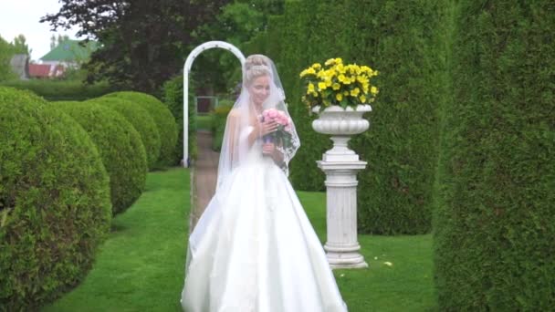 Portrait of a beautiful bride with a bouquet in a green Park, English style — Stock Video