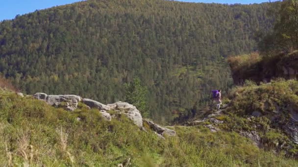 Активный альпинист с рюкзаком после восхождения на гору — стоковое видео