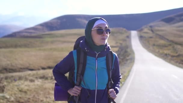 Ritratto di turista musulmano con zaino turistico e occhiali da sole in montagna, slow mo — Video Stock