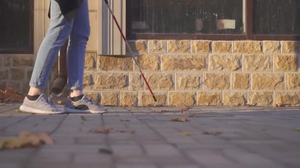 Woman walking down the street with a cane for the visually impaired,slow mo — Stock Video