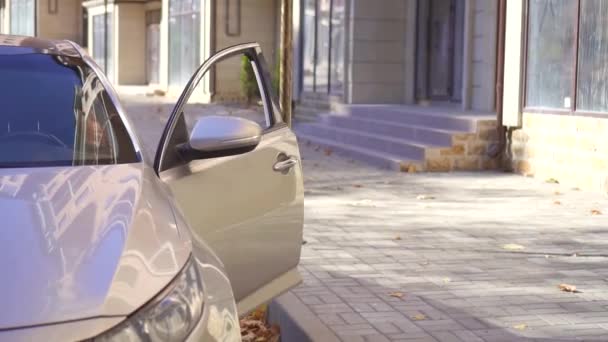 Muslim woman in hijab with phone in hand out of the car,slow mo — Stock Video