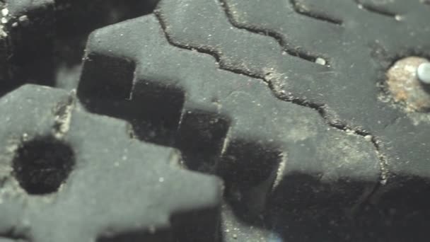 Extremely close-up of a steel spike on an old tyre — Stock Video