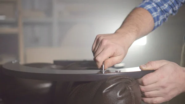 Hands of male master assembling furniture close-up in a dark workshop close up — Stock Photo, Image