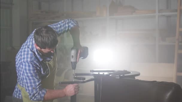 Professional man with a beard in a shirt is engaged in manufacturing furniture, a small business — Stock Video