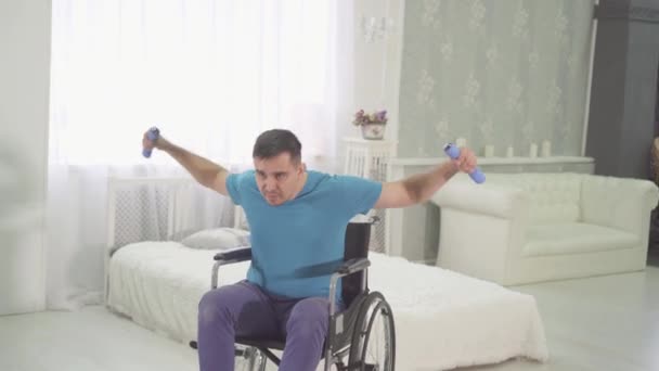一个在轮椅上残疾的体育男子的肖像, 在家里训练 — 图库视频影像