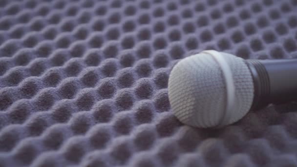 Concept idea, the microphone lies on the sound-absorbing sponge — Stock Video