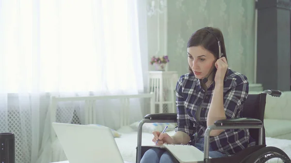 Porträt junge Frau behindert, Rollstuhl, Fernarbeit zu Hause, Computer-Headset — Stockfoto