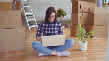 taşıma için kutular arasında laptop ile genç kadın