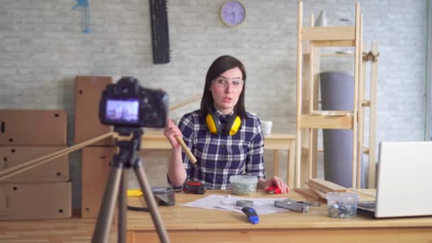 Young woman DIY blogger recording video in garage workshop — Stock Video