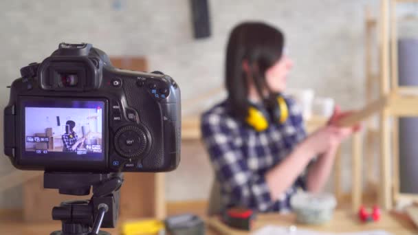 Young beautiful woman DIY blogger recording video in garage workshop, hand tools — ストック動画