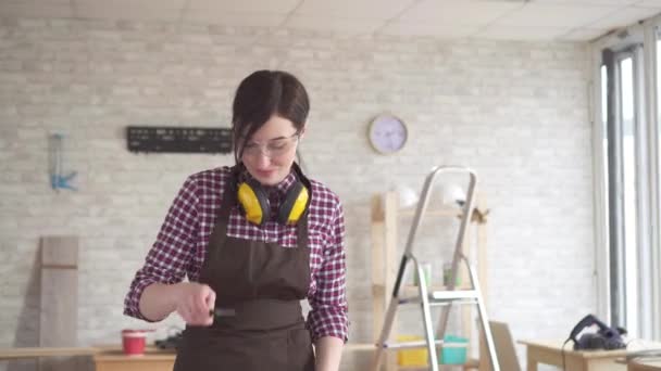 Professional young worker woman in eyeglasses skillfully uses hand tools — Stock Video