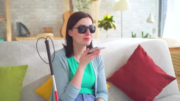 Portrait young visually impaired woman talking on the phone — Stock Video