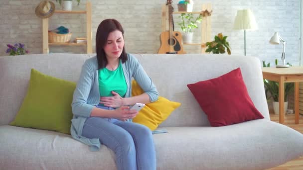Dolor abdominal agudo en una mujer usando un teléfono inteligente — Vídeos de Stock