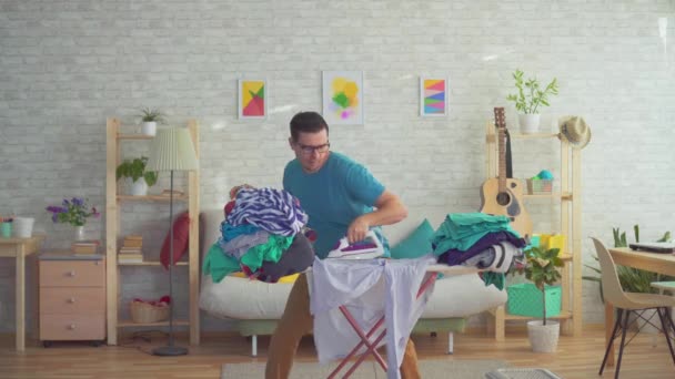 Young man dancing and Ironing clothes — Stock Video