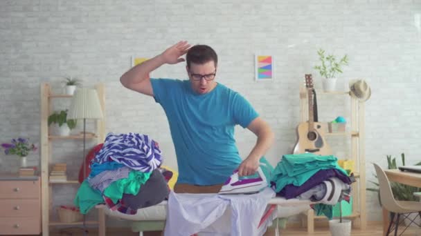 Close up young man dancing and Ironing clothes — Stock Video