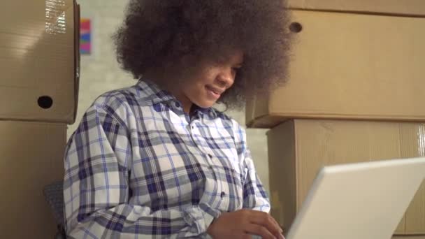 Yerde oturan ve bir laptop kullanarak bir afro saç modeli ile Afrikalı kadın yakın — Stok video