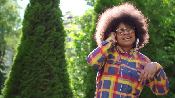Портрет танцює весело афроамериканська жінка з зачіскою на вулиці крупним планом — стокове відео