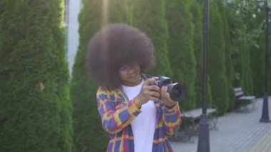 Kentsel peyzaj bir kamera ile bir afro saç modeli fotoğrafçı ile Portre Afrikalı kadın