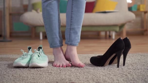 Problem of choosing a woman chooses sneakers instead of shoes with heels — Stock Video