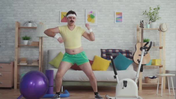 Expressive overweight man with a mustache and glasses funny dancing slow mo — Stock Video