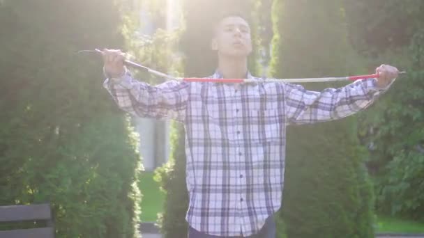 Молодой слабовидящий азиат с тростью в парке — стоковое видео