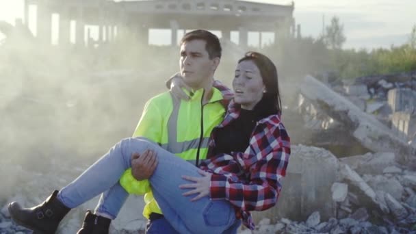 Man rescue worker in a uniform is on the hands of the earthquake victim slow mo — Stock Video