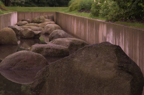 Canal de estanque con piedras en el fondo del parque —  Fotos de Stock