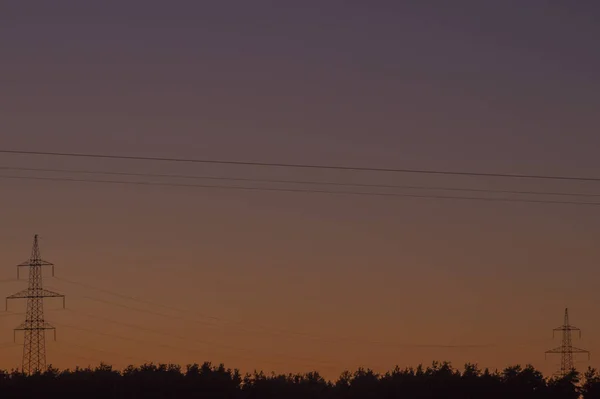 Высокое напряжение башни с силуэтом неба заката фона — стоковое фото