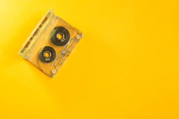 Retro cassette tape over yellow table. top view. copy space — Stock Photo, Image