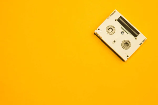 Digital video cassette on yellow background — Stock Photo, Image