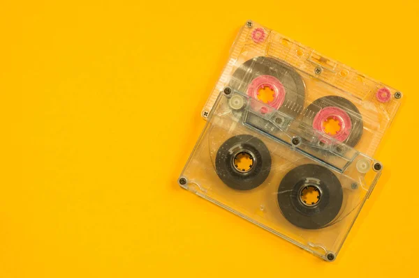 Retro cassette tape over yellow table. top view. copy space — Stock Photo, Image