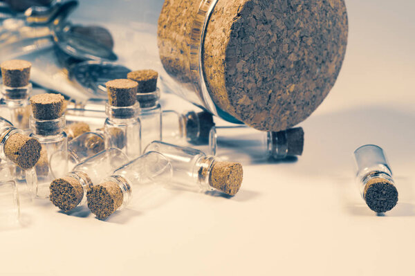 Empty little bottles with cork stopper isolated on white. big bottle with cork. transparent containers