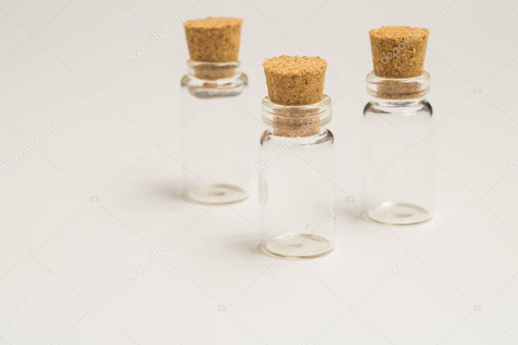 Empty little bottles with cork stopper isolated on white. transparent containers. test tubes
