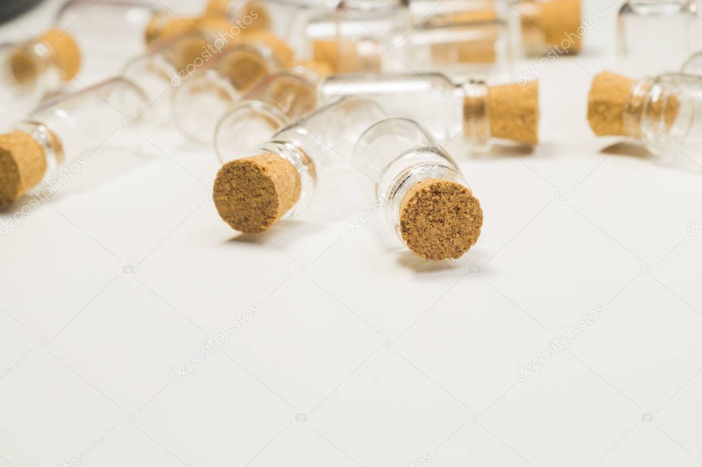 Empty little bottles with cork stopper isolated on white. transparent containers. test tubes. copy space