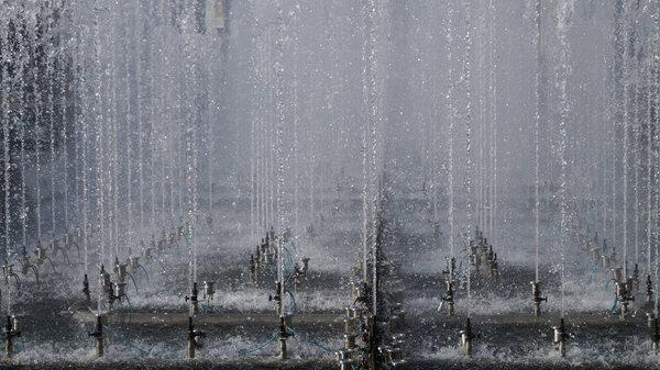 High fountain spraying water in the park. fountain spray system