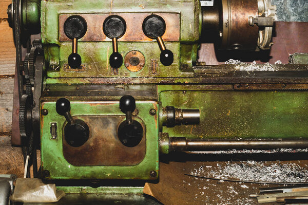 Old lathe. detail of rusty machine. metal mechanism. vintage metalworking machine close up. industrial background