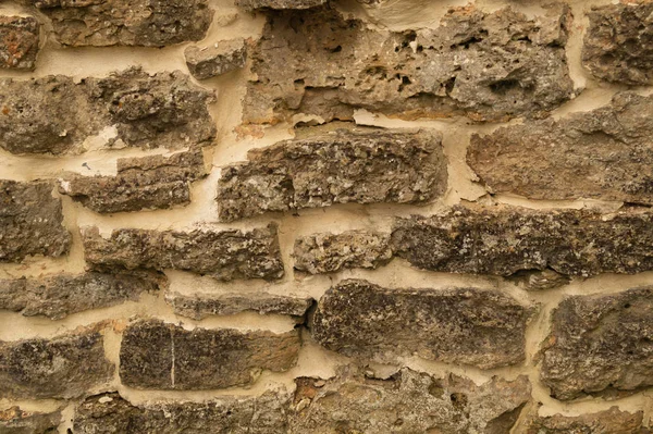 Βραχώδης τοίχος από τούβλα. πέτρινο φόντο τοίχου. αφηρημένη γκραντζ υφή. παλιά καφέ τοιχοποιία — Φωτογραφία Αρχείου
