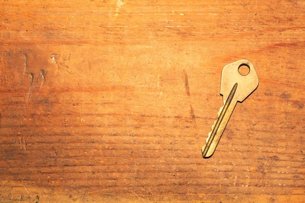 Key isolated on a wooden background. safety and security concept — Stock Photo, Image