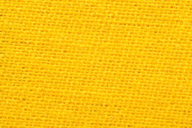 Sarı tekstil yakın çekim. Örgü kumaş dokusu. örülmüş malzeme arkaplanı