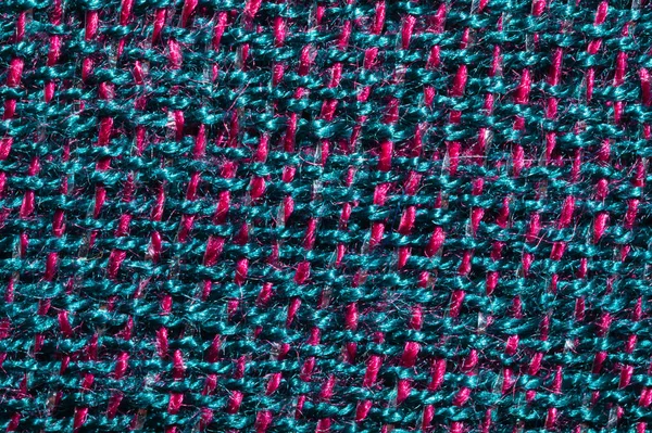 Kumaş makro doku. Örgü tekstil. Örülmüş arka plan. Yünlü kumaş. Mavi ve kırmızı iplikler birbirine yakın