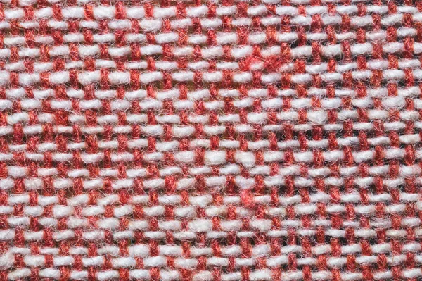 Kumaş makro doku. Örgü tekstil, yakın çekim. Örülmüş arka plan. Yünlü kumaş. Kırmızı ve beyaz ipliklerin dokuması