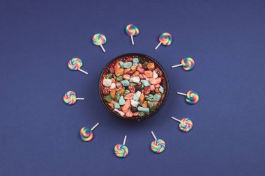 Lolipop ve şeker. Renkli taşlar şeklinde şekerleme kasesi. Boşluğu kopyala