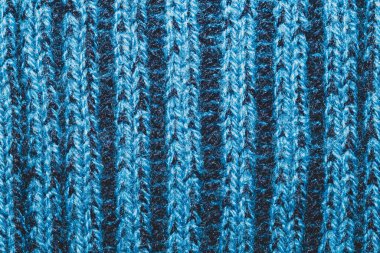 Mavi kumaş dokusu. Örülmüş tekstil geçmişi. Dokuma malzemesi. Yakın çekim. Yün ipliğinden örgü örmek