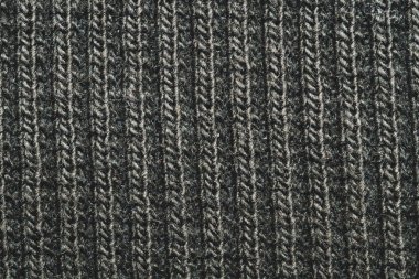 Siyah kumaş dokusu. Örülmüş tekstil geçmişi. Dokuma malzemesi. Yakın çekim. Yün ipliğinden örgü örmek