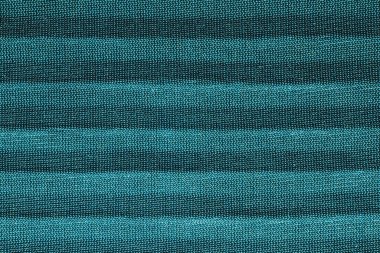 Paralel kıvrımlı yeşil tekstil. Düz çizgili kumaş dokusu. Kumaş arkaplanı kapat