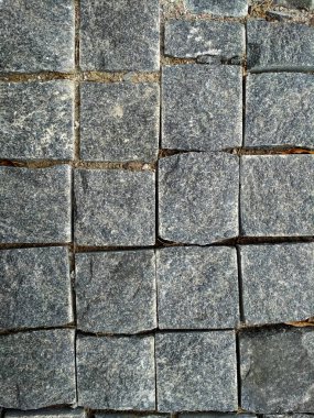 Stone brick. Texture brick wall,Close-up brickly gray tiles. Street stone texture background.