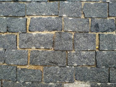Stone brick. Texture brick wall,Close-up brickly gray tiles. Street stone texture background.