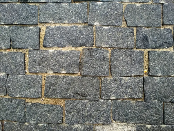 Stone brick. Texture brick wall,Close-up brickly gray tiles. Street stone texture background.