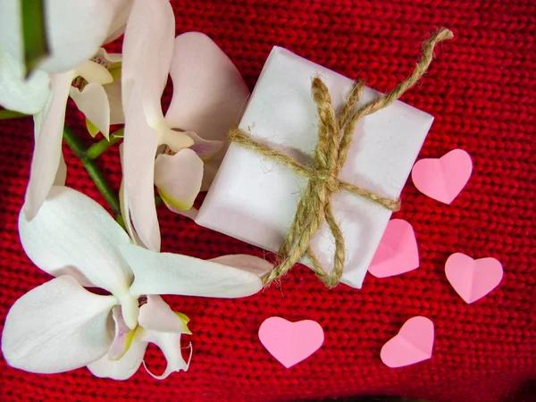 Orchid and hearts on red cloth, Valentines Day background, wedding day. — Stock Photo, Image