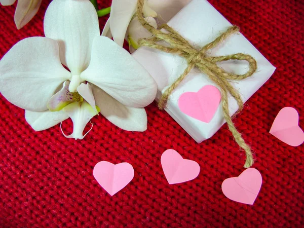 Orchid and hearts on red cloth, Valentines Day background, wedding day. — Stock Photo, Image